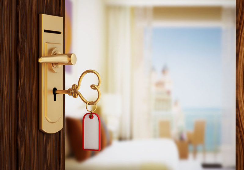 45653750 - heart shaped hotel room key on the door